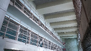 interior of a hallway of jail cells